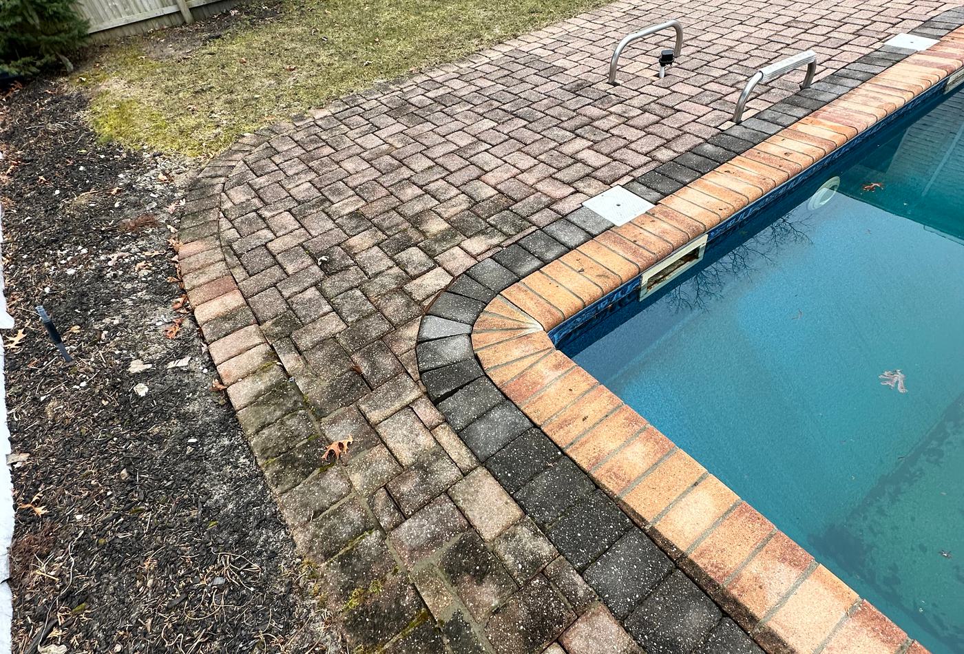 Pool deck pavers before cleaning