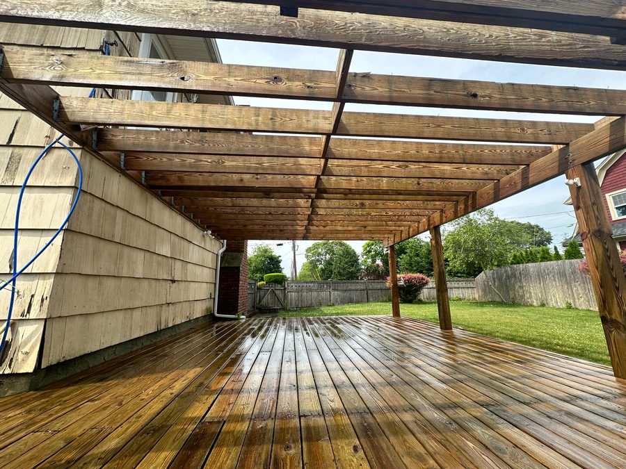 Restored wood deck under a pergola