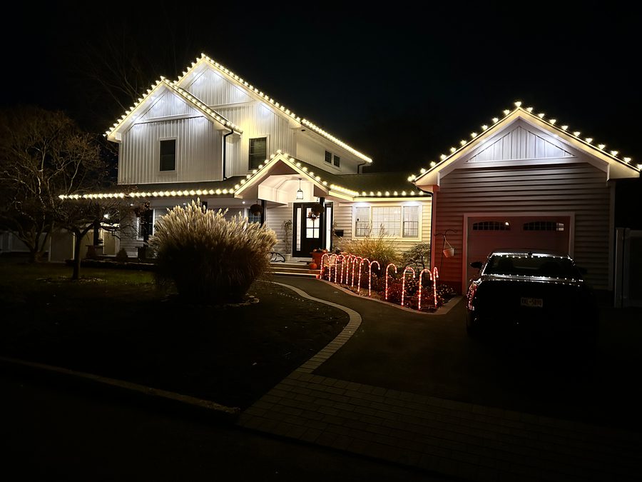 House with installed holiday lights at night