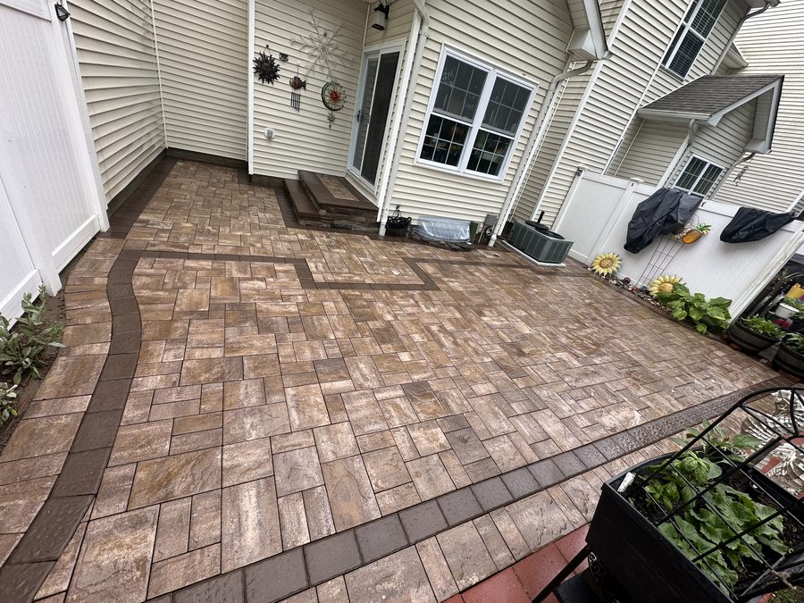 Cleaned paver patio behind a house